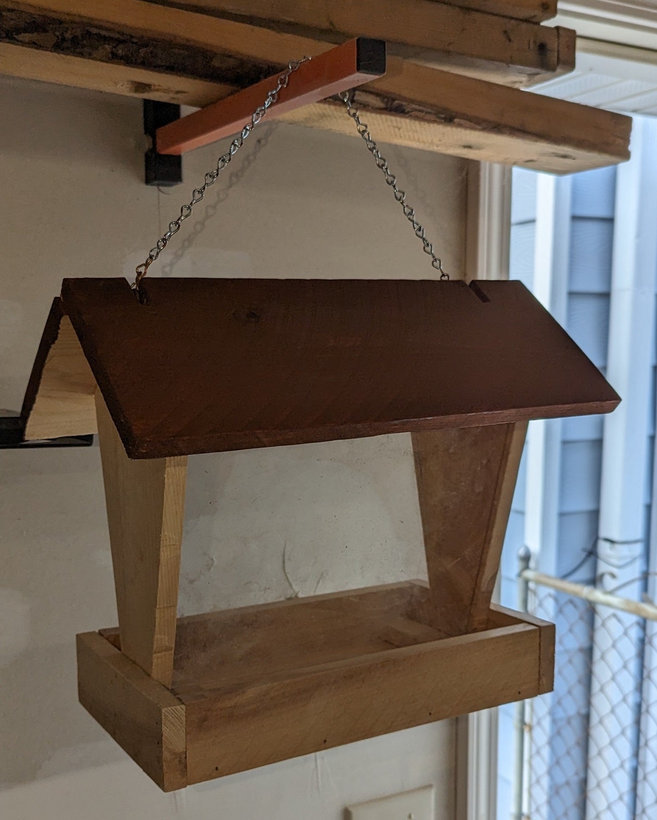 Bird Feeder made from cedar with hinged roof. 14 inches tall x 14 inches long x 10 inches wide, Holds 2 cups of birdseed.