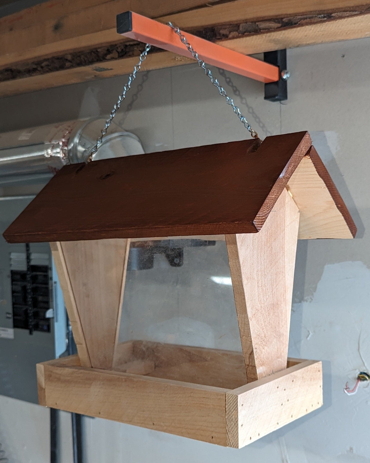 Bird Feeder made from cedar with hinged roof. 14 inches tall x 14 inches long x 10 inches wide, Holds 2 cups of birdseed.