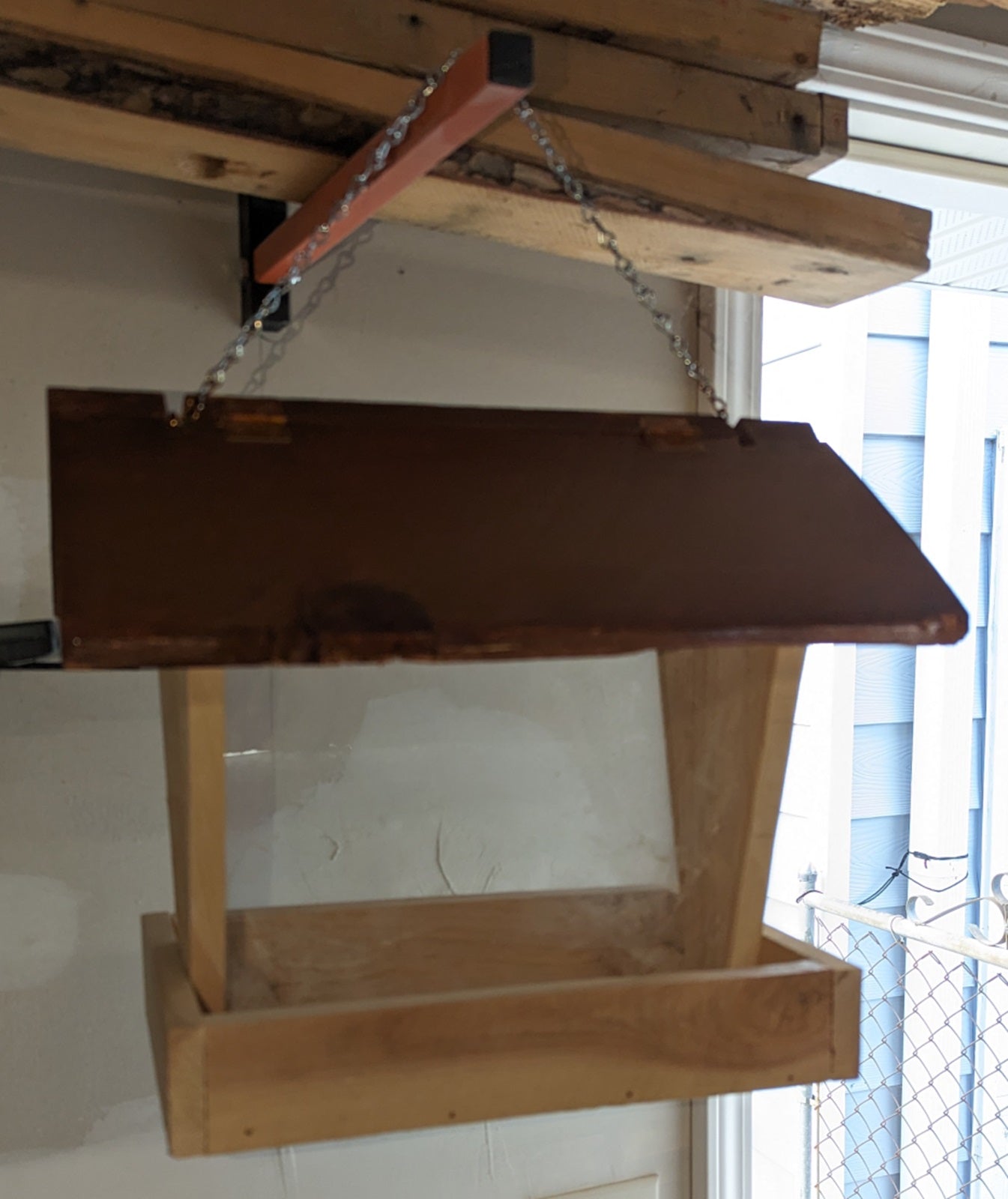 Bird Feeder made from cedar with hinged roof. 14 inches tall x 14 inches long x 10 inches wide, Holds 2 cups of birdseed.