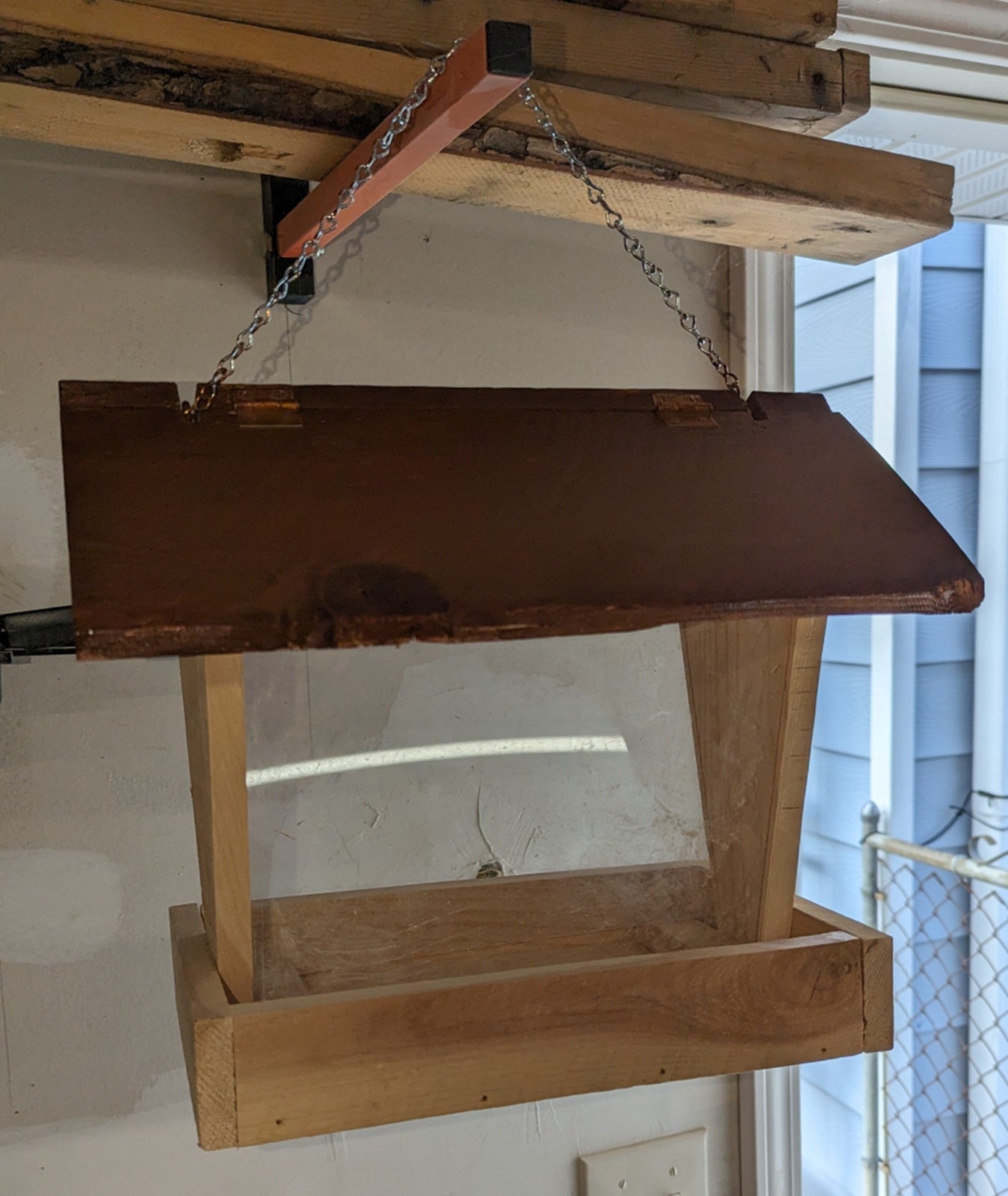 Bird Feeder made from cedar with hinged roof. 14 inches tall x 14 inches long x 10 inches wide, Holds 2 cups of birdseed.