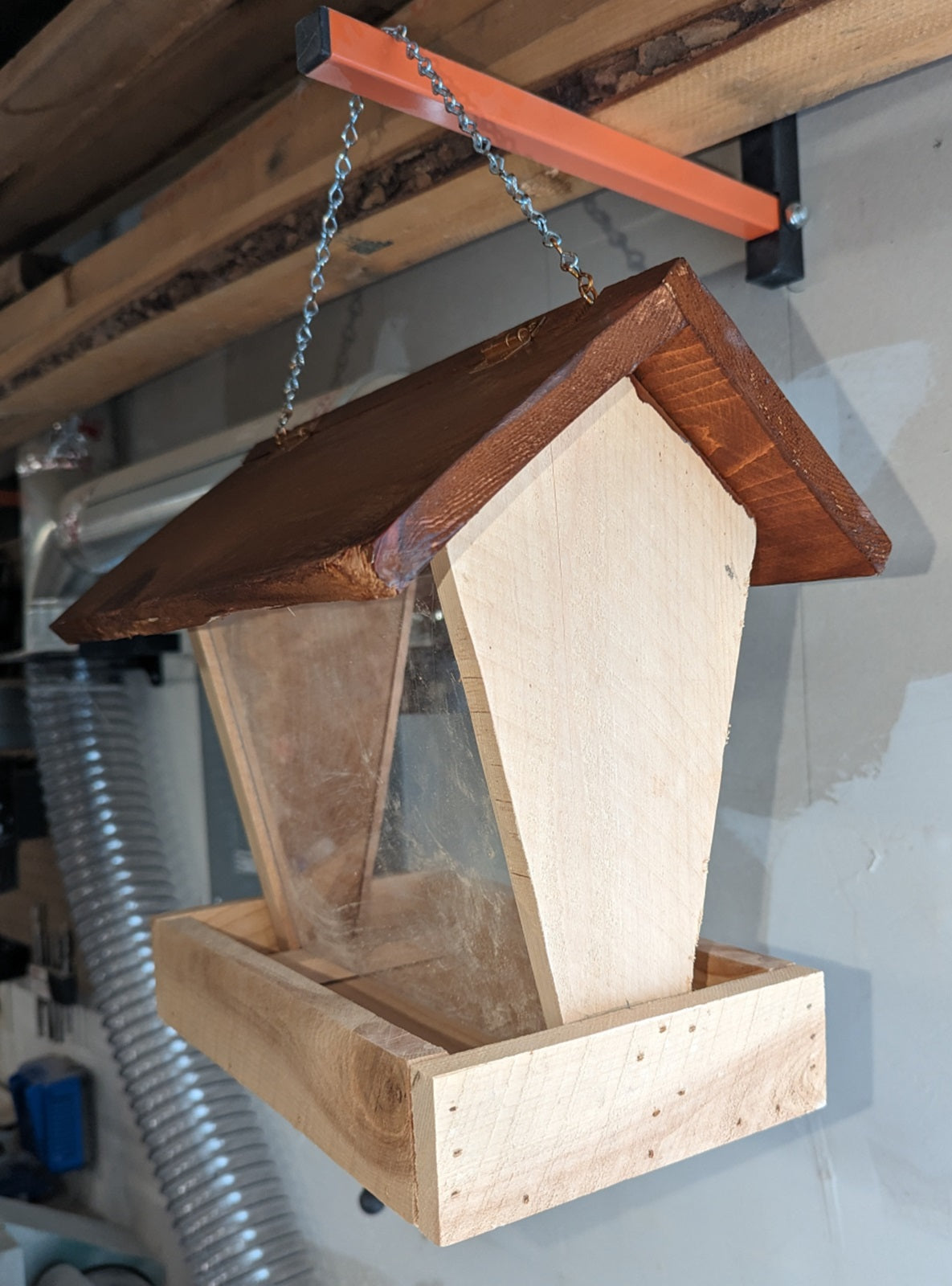 Bird Feeder made from cedar with hinged roof. 14 inches tall x 14 inches long x 10 inches wide, Holds 2 cups of birdseed.