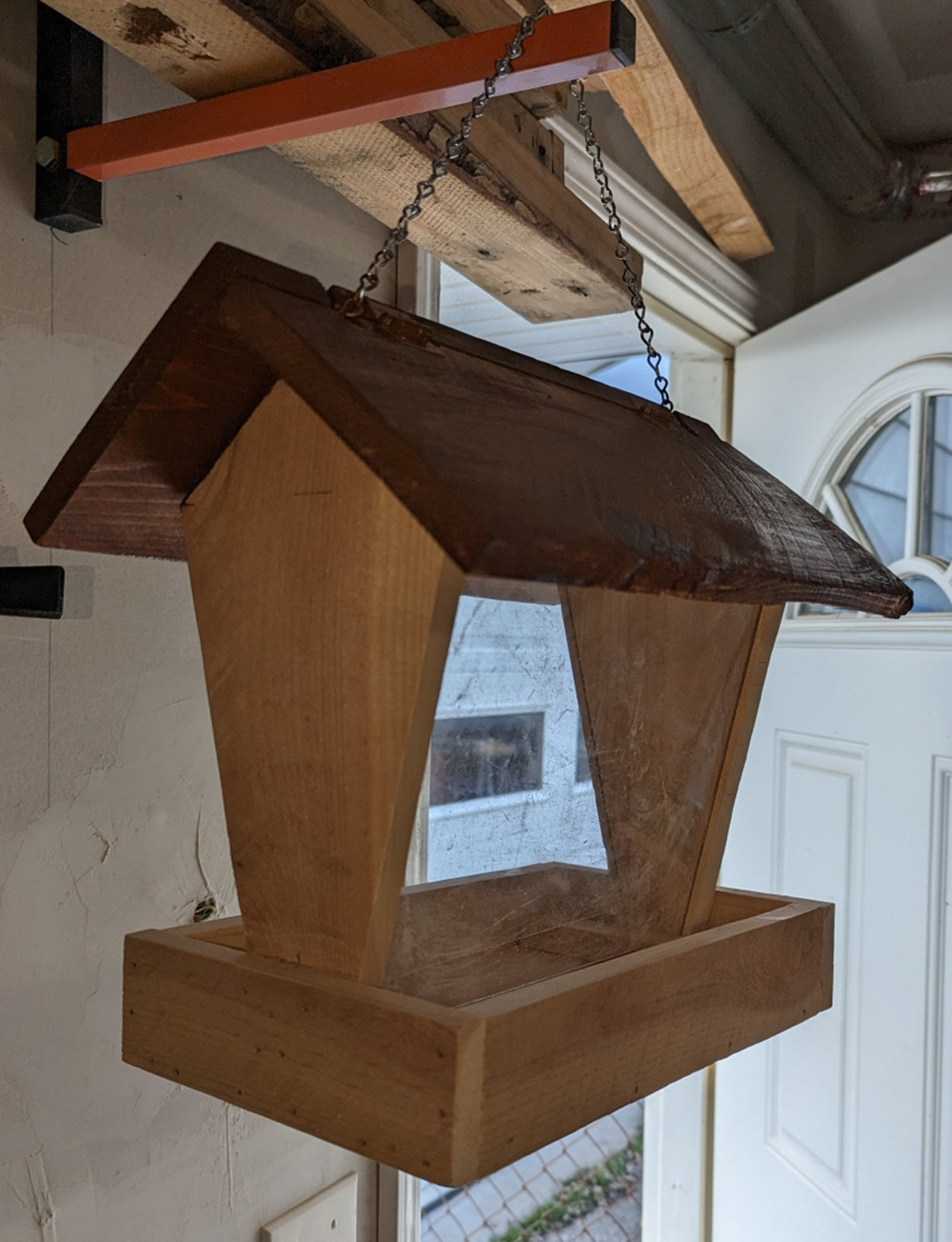 Bird Feeder made from cedar with hinged roof. 14 inches tall x 14 inches long x 10 inches wide, Holds 2 cups of birdseed.