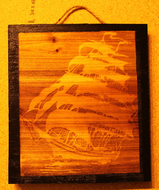 Decorative Sign with engraved Ghost Ship and black boarders that's 8 inches square.
