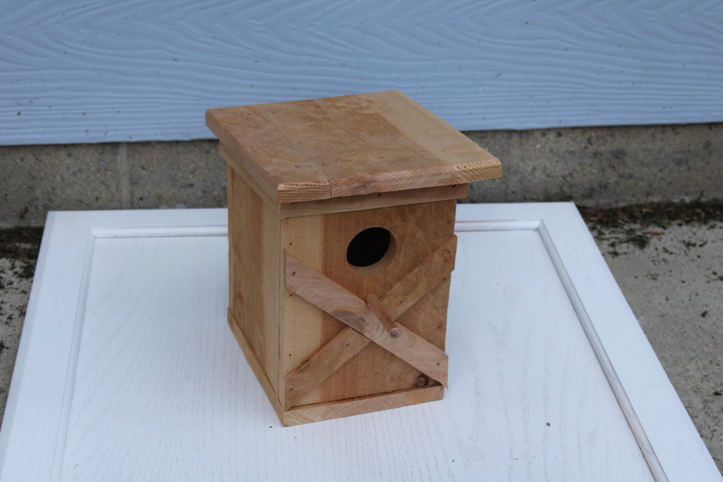 Bird House with an X pattern on front made from cedar